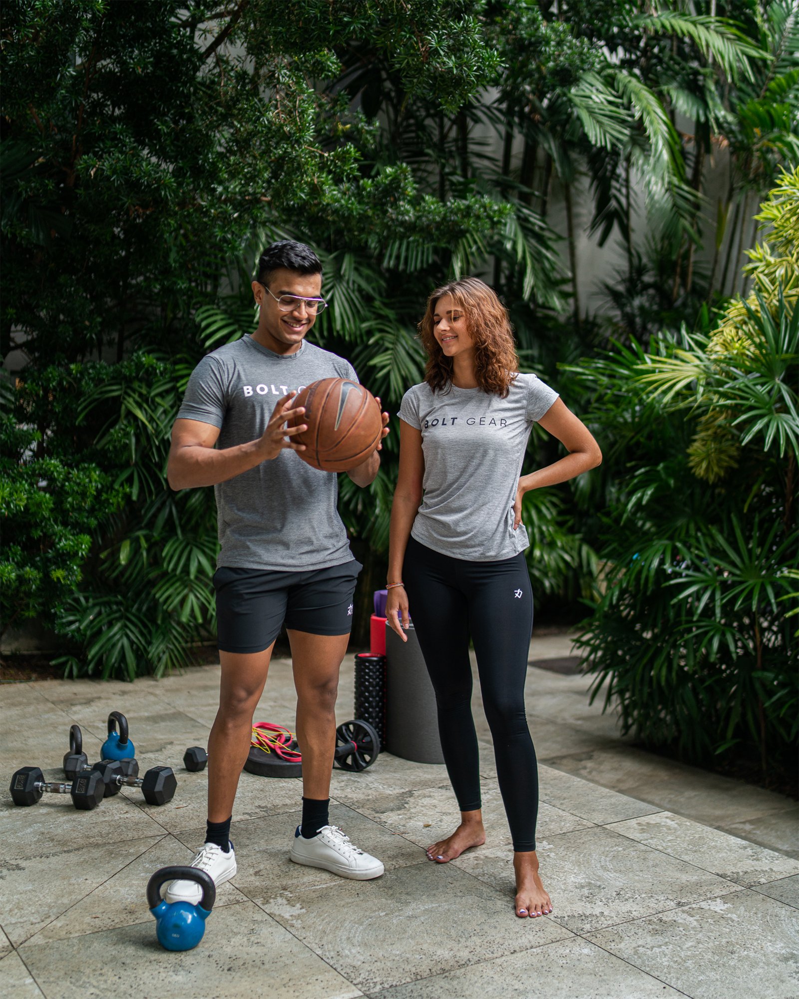 a man and woman holding a basketball